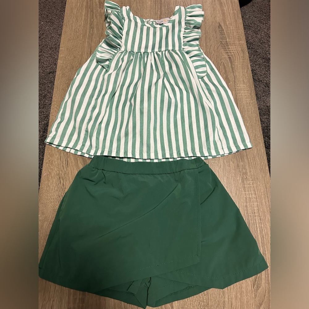 Girls matching set with skort and ruffle sleeve flow shirt. Never worn.